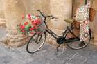 Noto, Sicily. Bike displays goods outside of a shop. Art Print